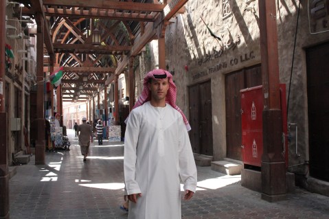 Michel dressed in a dishdash (white robe) and a  Keffiyeh (head scarf).